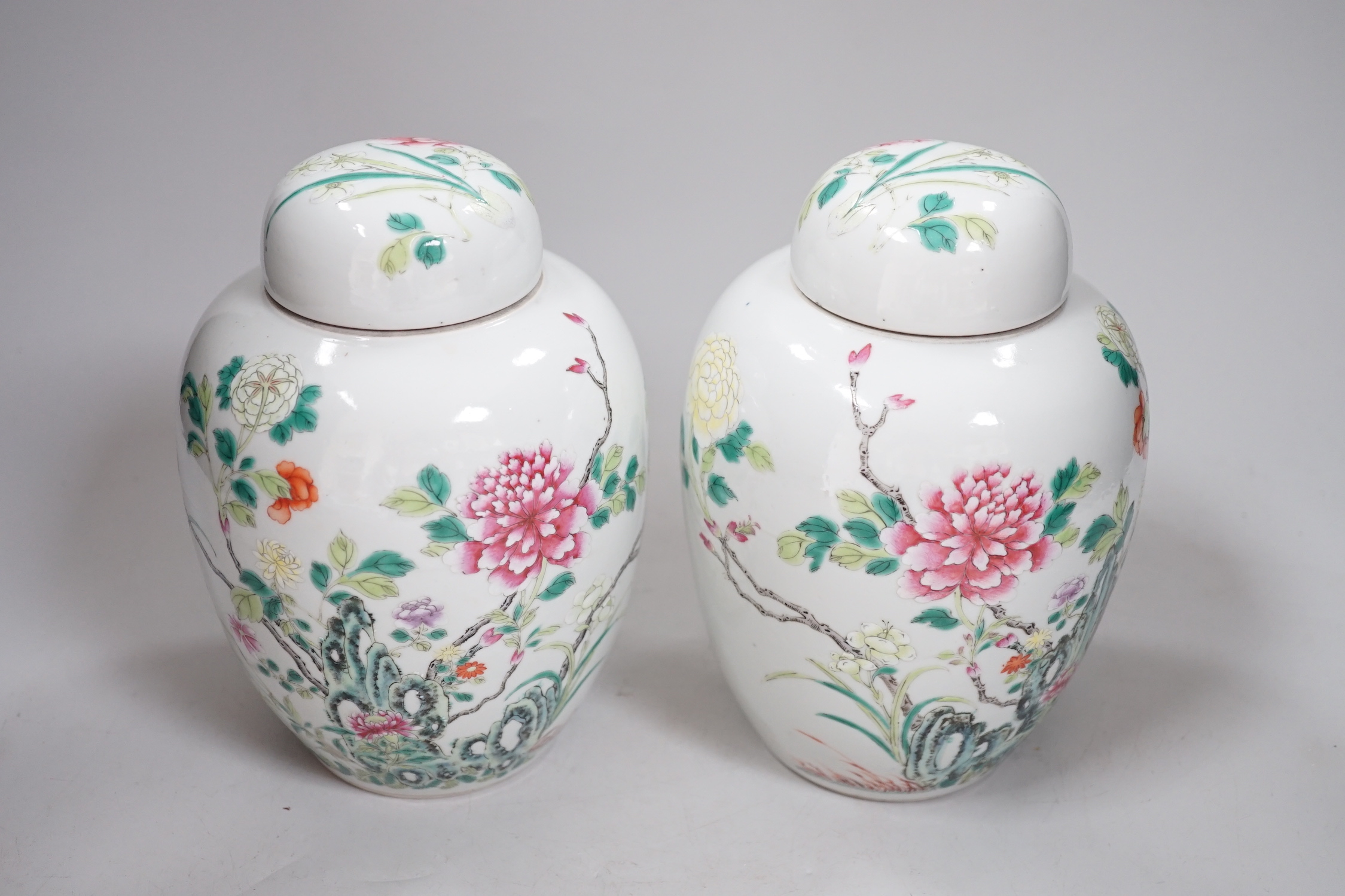 A pair of Chinese famille rose jars and covers, Qianlong seal marks, late 19th century, 20cm high